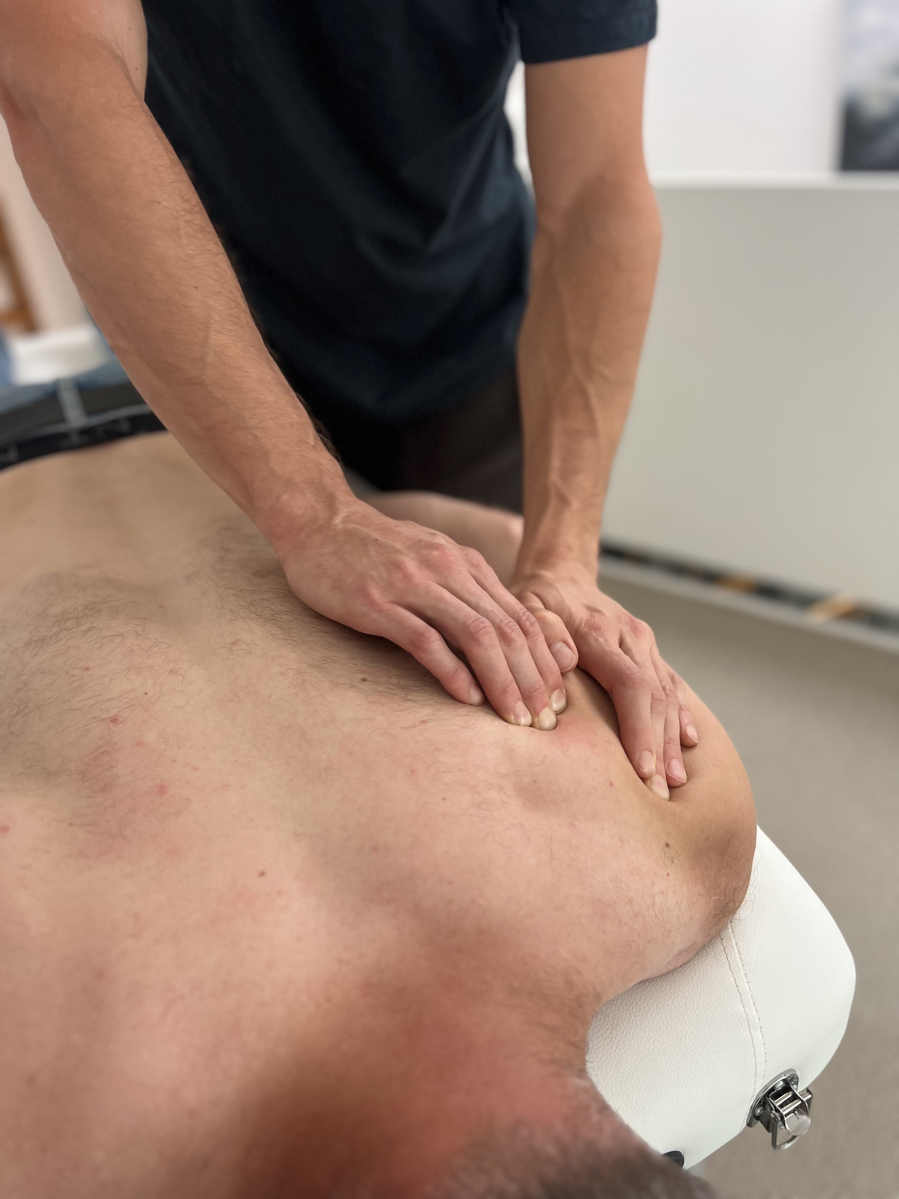 Massage therapist performing deep tissue work